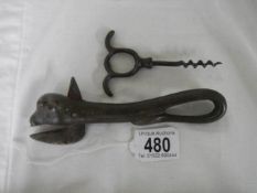 A vintage can opener and corkscrew.