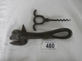 A vintage can opener and corkscrew.