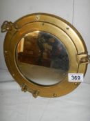 A brass ship's porthole mirror.