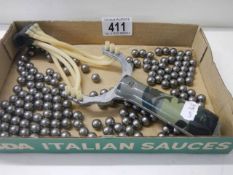 A sling shot and a quantity of ball bearings.