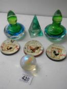 Five paperweights and two scent bottles.