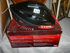 A boxed cycle helmet.