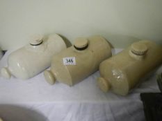 Three stoneware hot water bottles.