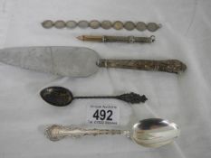 A mixed lot including cake slice, spoons, coin bracelet etc.,