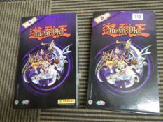 Two empty Panina YU-GI-OH collector's albums with 4 plastic containers