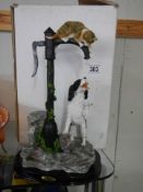 A good figure of a cat and dog on a water pump.