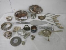 A mixed lot of silver plate including wine coaster, flatware etc.,
