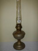 A brass oil lamp with chimney.