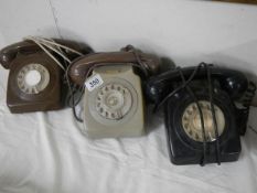 Three vintage telephones.