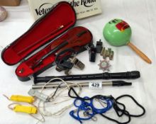 A mixed lot of whistles, recorder, maraca, mini violin and a penny whistle etc.