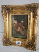 A gilt framed study of a boy violinist.