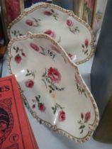 A pair of rose decorated dishes.