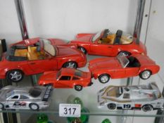 A quantity of die cast sports cars.