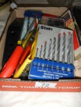 A mixed lot of tools including new drill bits.