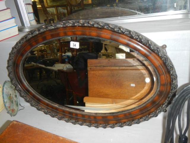 An oval framed bevel edged mirror, COLLECT ONLY.
