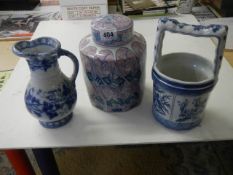 An early 19th century blue and white jug together with a later ginger jar and bucket.