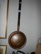 A copper warming pan. COLLECT ONLY