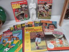 A quantity of football related books and a figure.