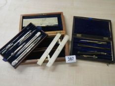 A quantity of drawing compass sets.