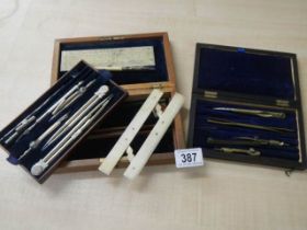 A quantity of drawing compass sets.