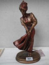 A contemporary figure of a lady golfer.