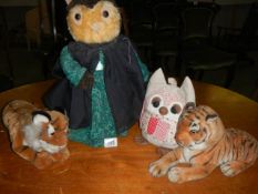 An owl doorstop, two soft toy tigers and another owl.