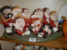 A hand made ceramic tug 'o' war figure group. 1 arm a/f and some chips to paint