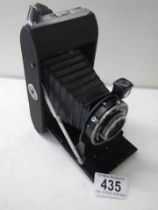 A vintage Ensign folding camera in case.