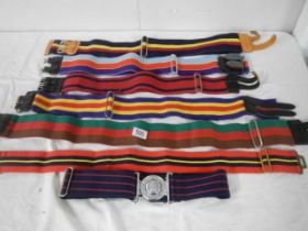 A quantity of vintage striped belts including military.