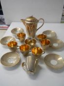 A Jersey pottery gilded coffee set. COLLECT ONLY.