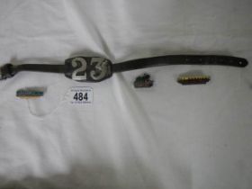 Three train badges and a belt.