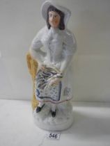 A 19th century Staffordshire figure (a/f crack in back).