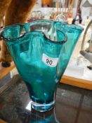 A turquoise coloured studio glass vase.