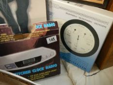 A boxed weather station and a clock radio.