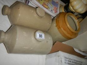 Two stoneware hot water bottles and a stoneware jar.