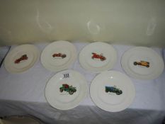 Four collector's plates decorated with vintage cars.