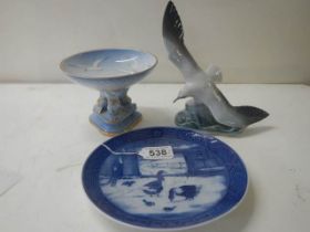 A blue and white plate, a comport and a seagull figure.