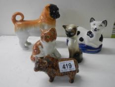Three cat figures, a dog and a cow.