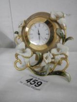 A Peace Lily decorated mantel clock.