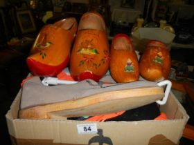 A quantity of wooden clogs, other shoes & shoe stretchers.