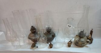 A quantity of Victorian oil lamps and chimneys