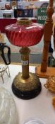 A Victorian oil lamp with cranberry cut glass font (Cracked) COLLECT ONLY