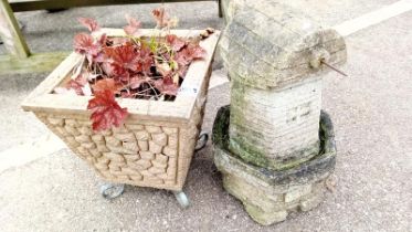 A stone pot on metal legs & windmill