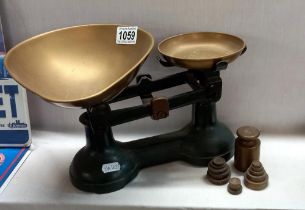 A set of kitchen scales with weights.
