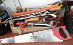 A large collection of saws etc