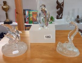 A Swarovski penguin & 2 glass figures of a seahorse of dolphins