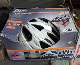 A boxed, unused cycle helmet & Crivit shorts