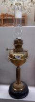 A brass oil lamp base with pot base.