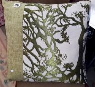 A designer cushion featuring tree branches (55cm x 55cm)