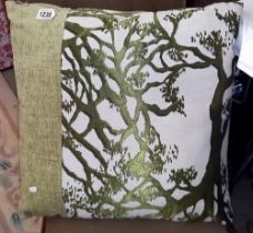 A designer cushion featuring tree branches (55cm x 55cm)